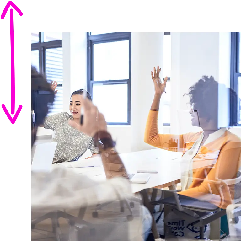 women in a conference room raising their hand