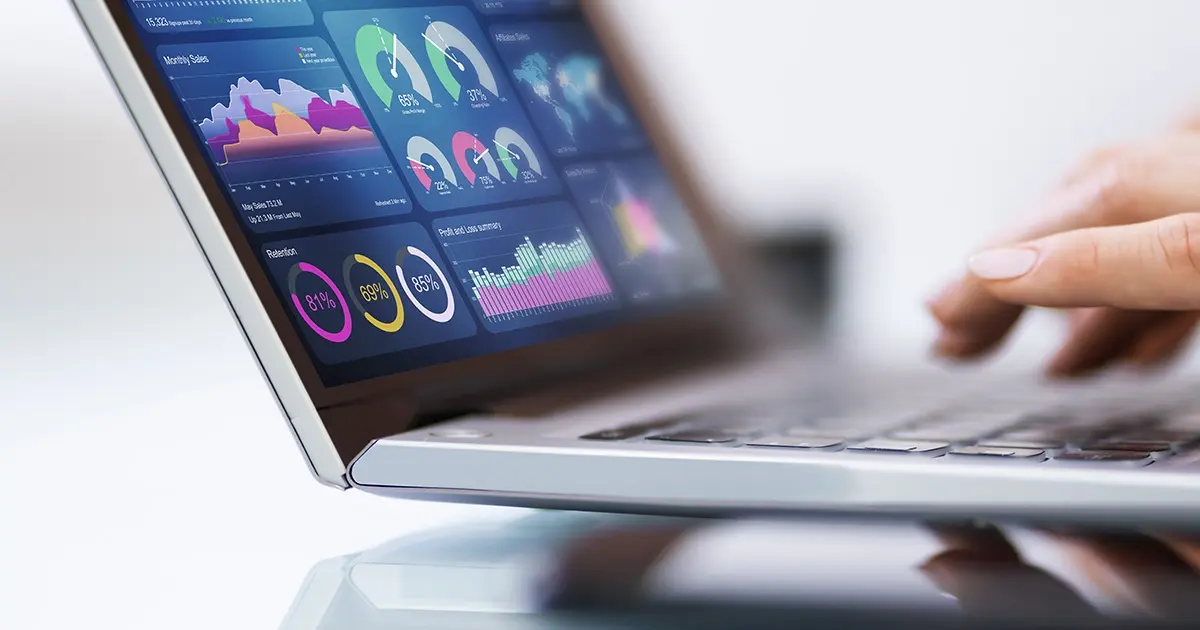 laptop with dashboard of charts on it