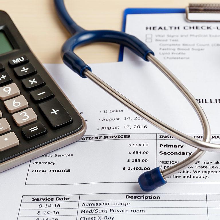 stethoscope and calculator on invoice paper