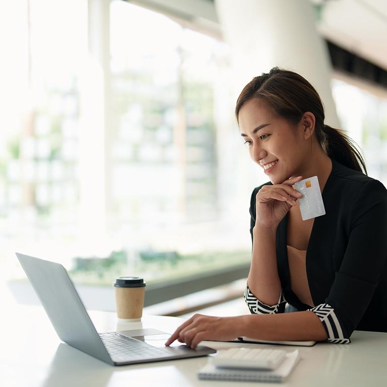 woman with credit card using a laptop