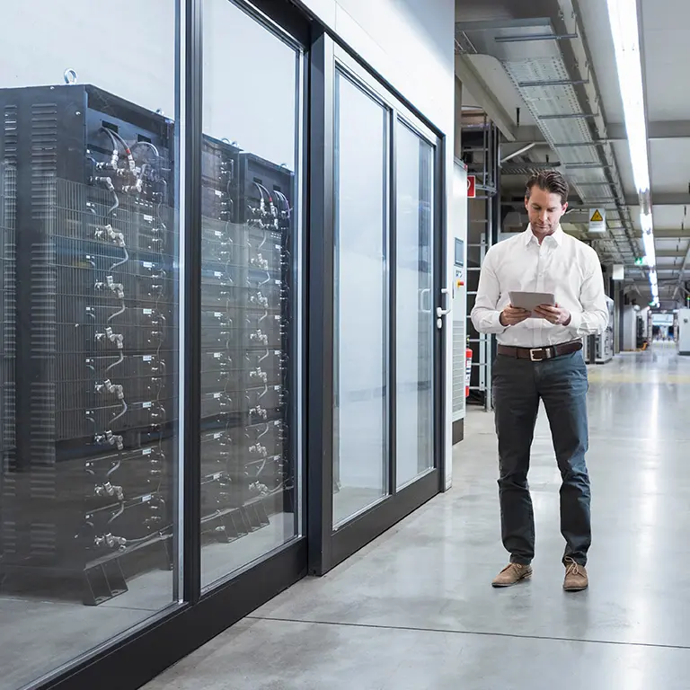 Man at work reviewing status of company servers on his tablet