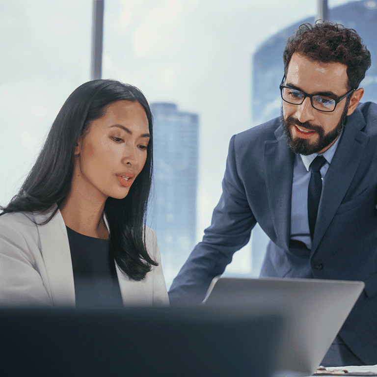 Coworkers looking over a computer