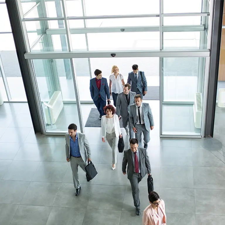 people in suits walking into a building