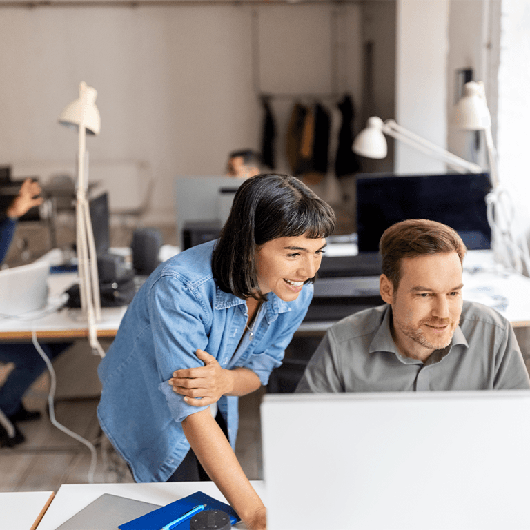 coworkers looking over a computer