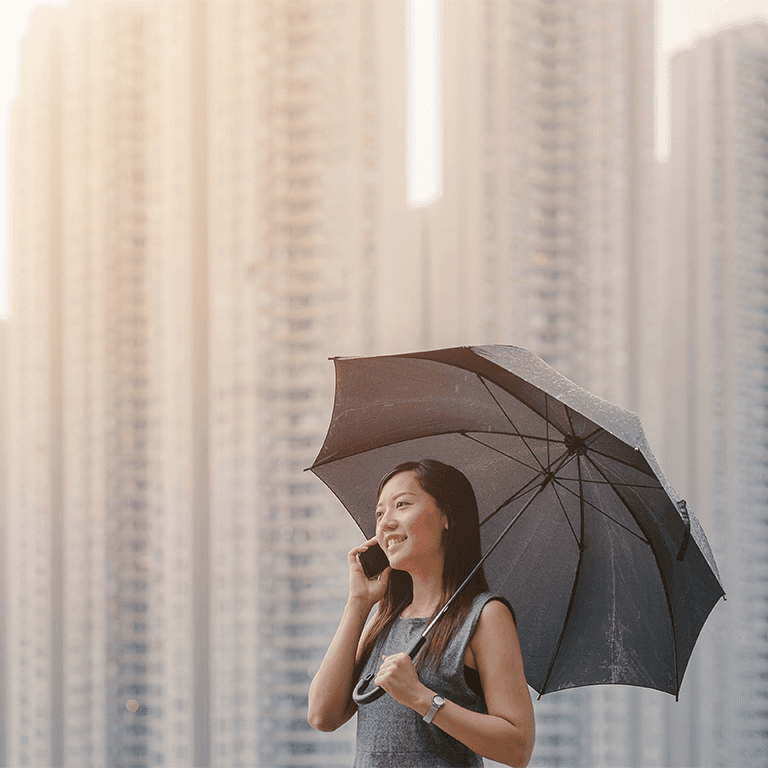 Woman talking on the phone holding an umbrella