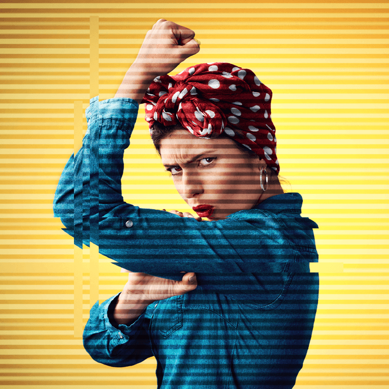 Woman dressed and posed as Rosie the riveter