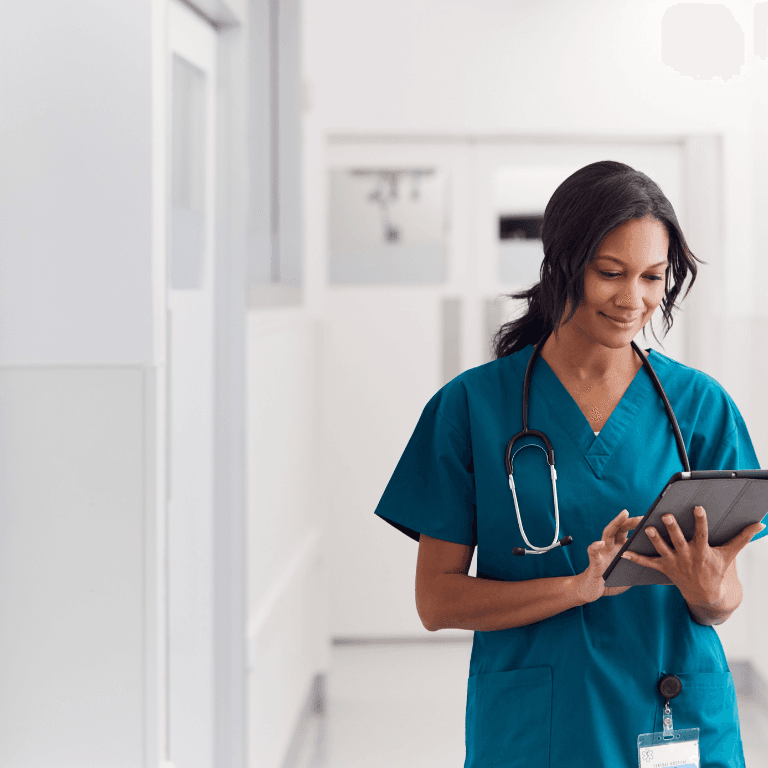 healthcare professional in scrubs holding a tablet
