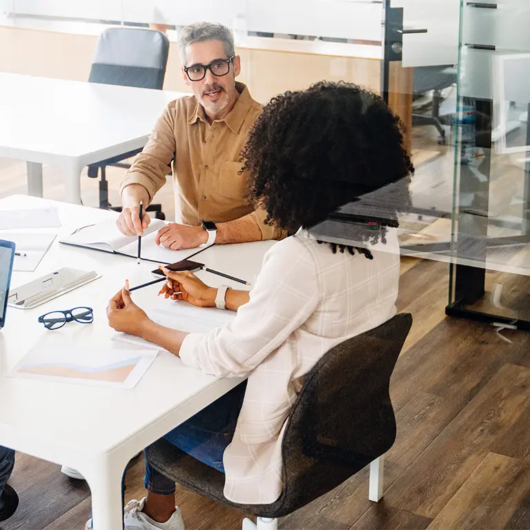 two people talking at a conference table