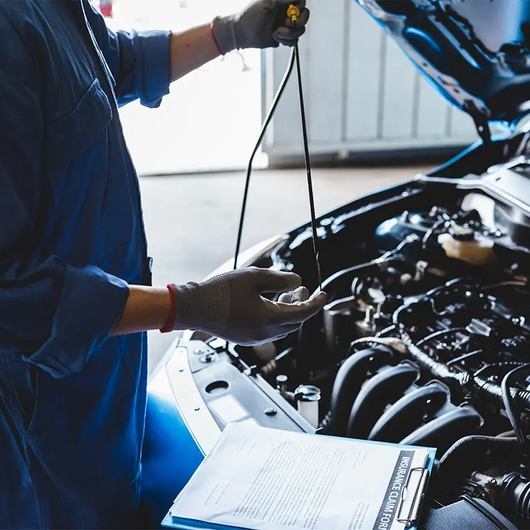 person working under the hood of a car