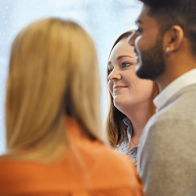 Three people looking out of frame