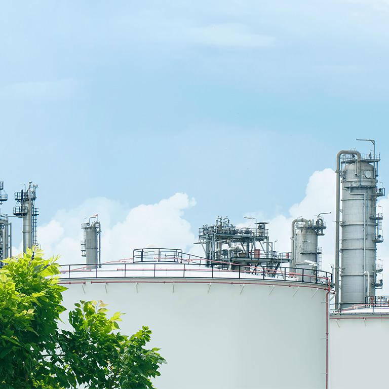 landscape of a factory and blue sky and a tree
