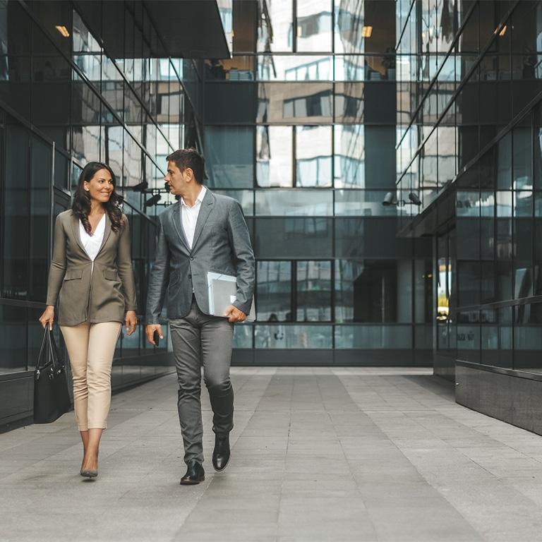 two people walking in a modern building