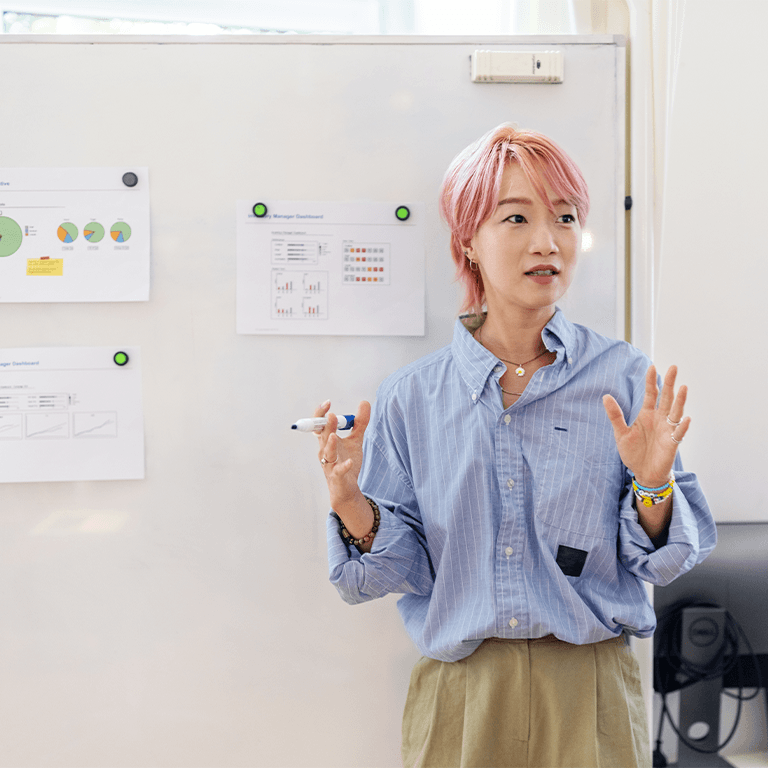 woman presenting at a whiteboard