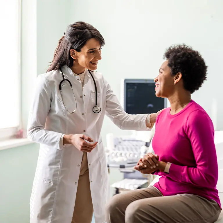 female doctor comforting her female patient