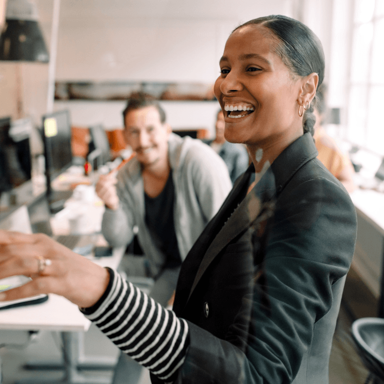Woman showing male coworker computer