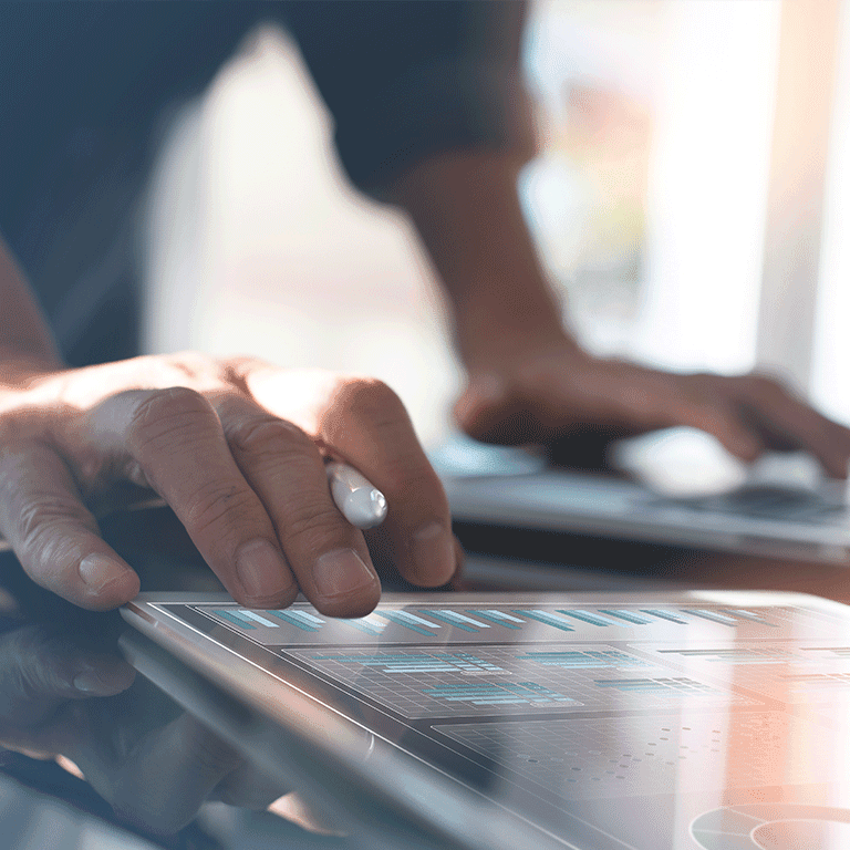 hand over a tablet with charts on it