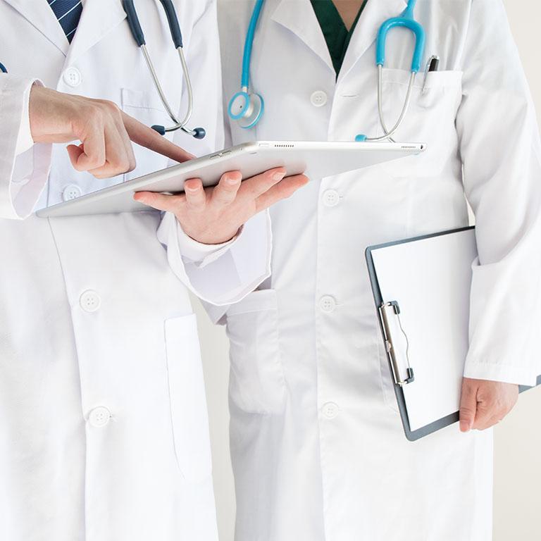 two doctors looking at an ipad