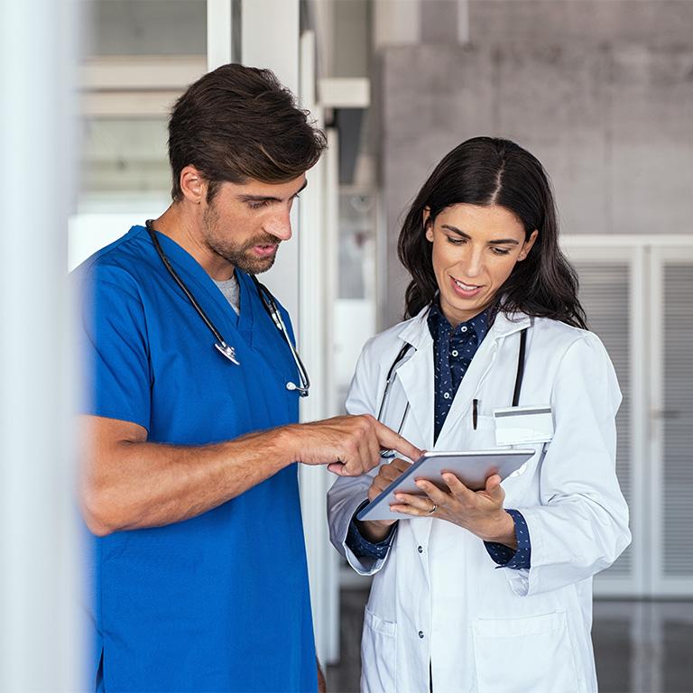medical employees checking an ipad