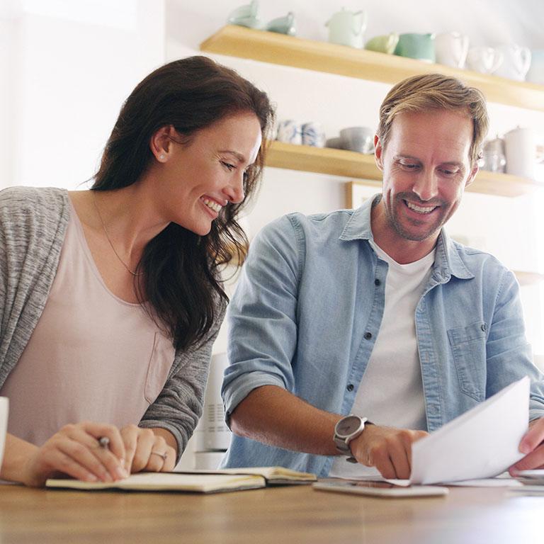 man and woman looking at some papers
