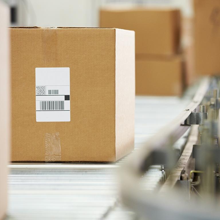 brown cardboard box on a conveyor belt