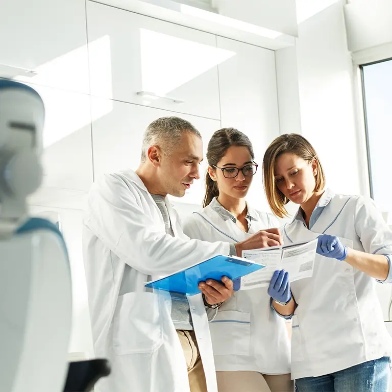 health professionals talking together looking at patient charts