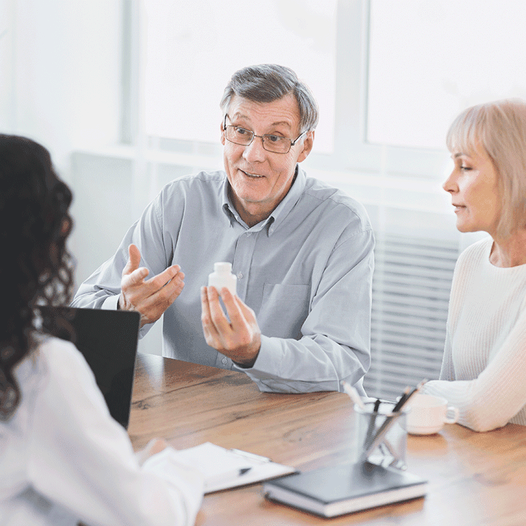 three people discussing medication