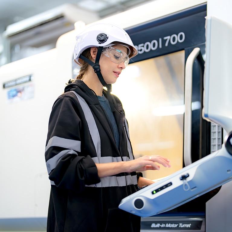 woman using manufacturing machine