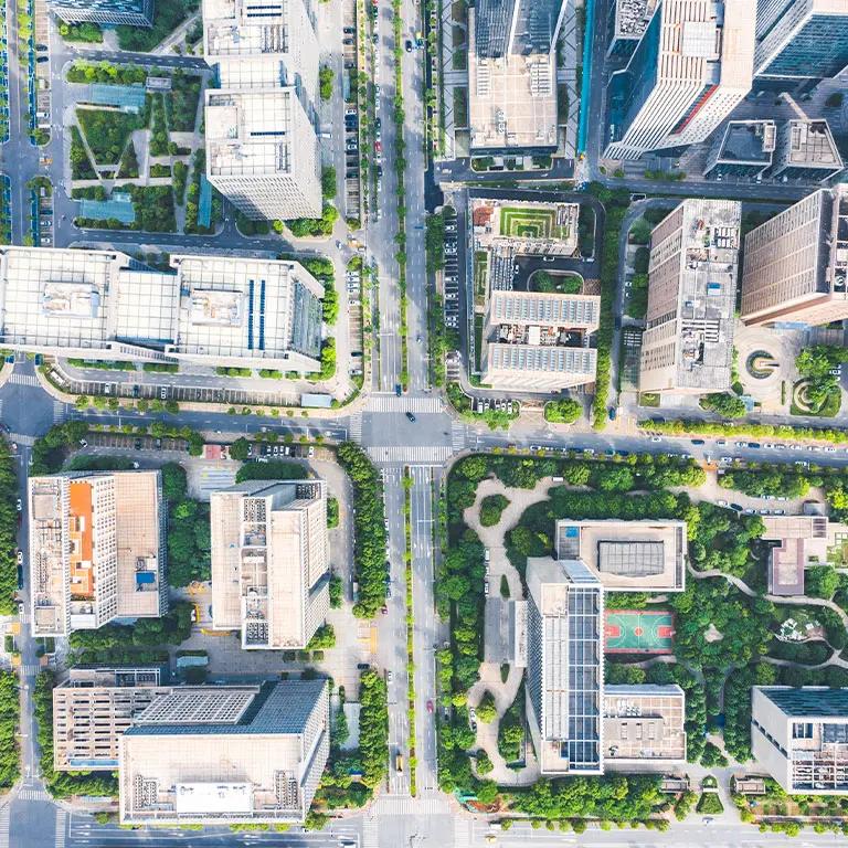 aerial view of city buildings, streets, and trees
