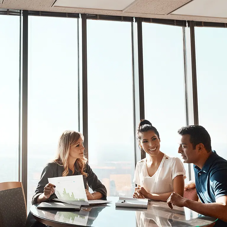 people at a table looking over a graph