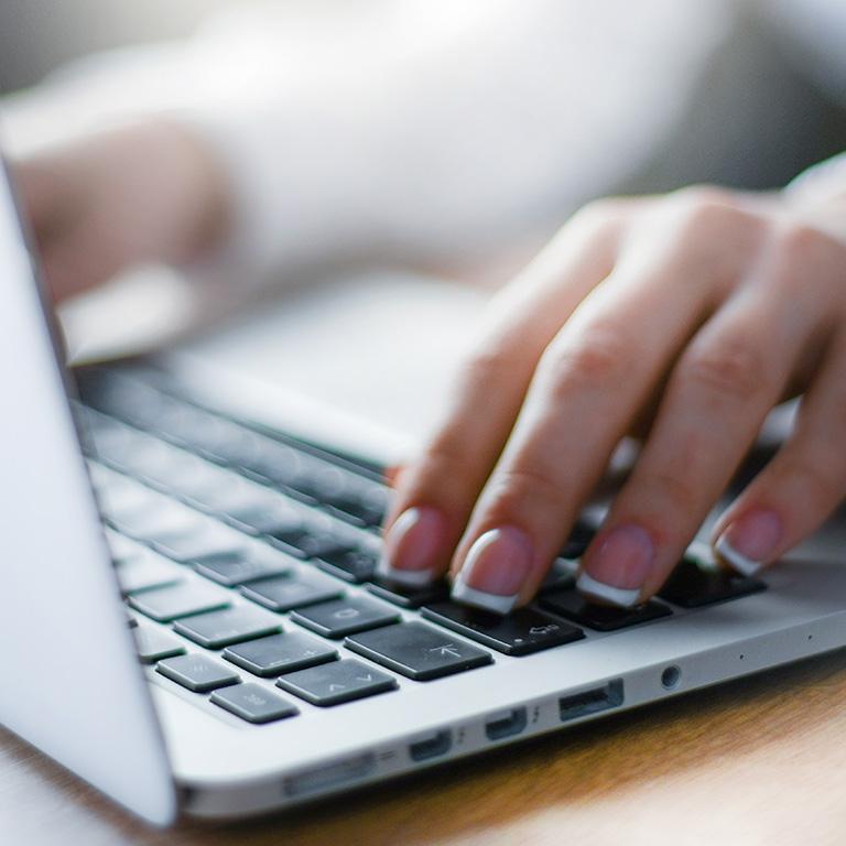 hands on a laptop keyboard