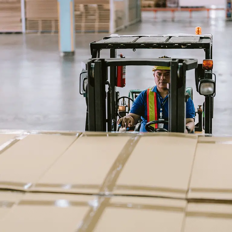 man operating a forklift with boxes on it