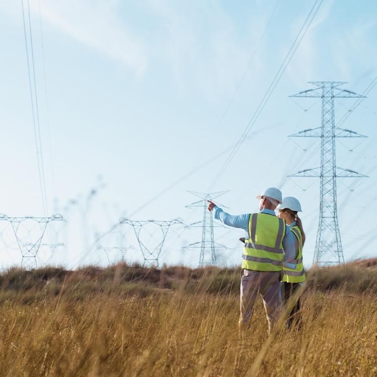 utility workers surveying telecom towers