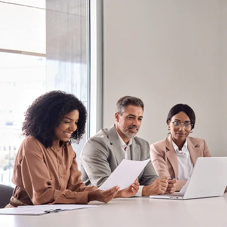 people seated at a table going over documents