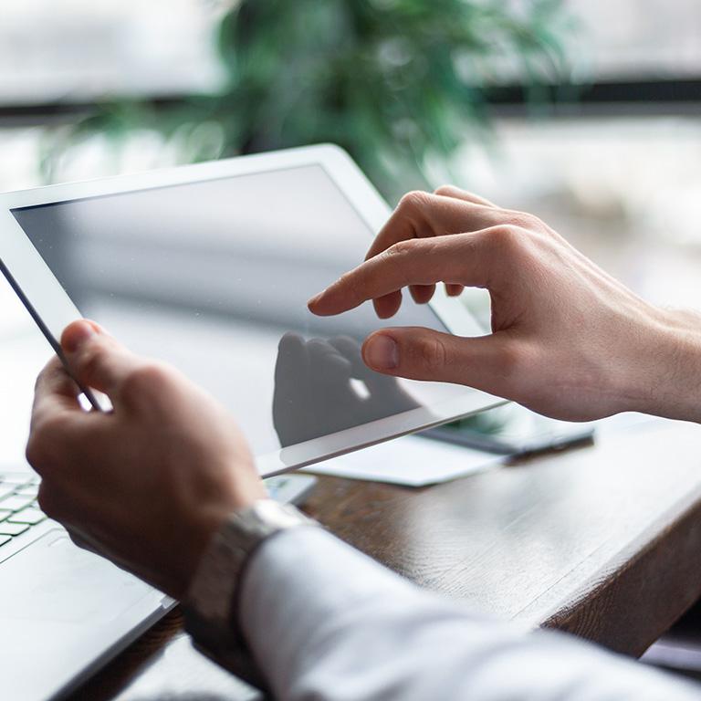 hands touching a tablet