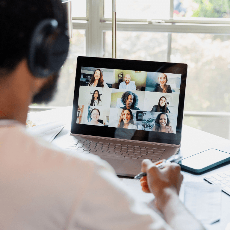 people's faces on a video call framed in a laptop
