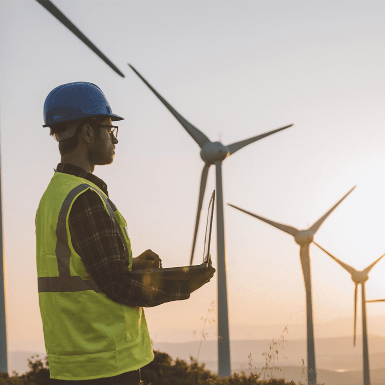 man taking notes on wind turbines