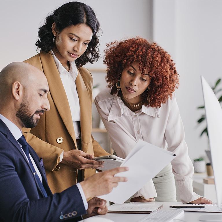 business people reviewing a piece of paper together