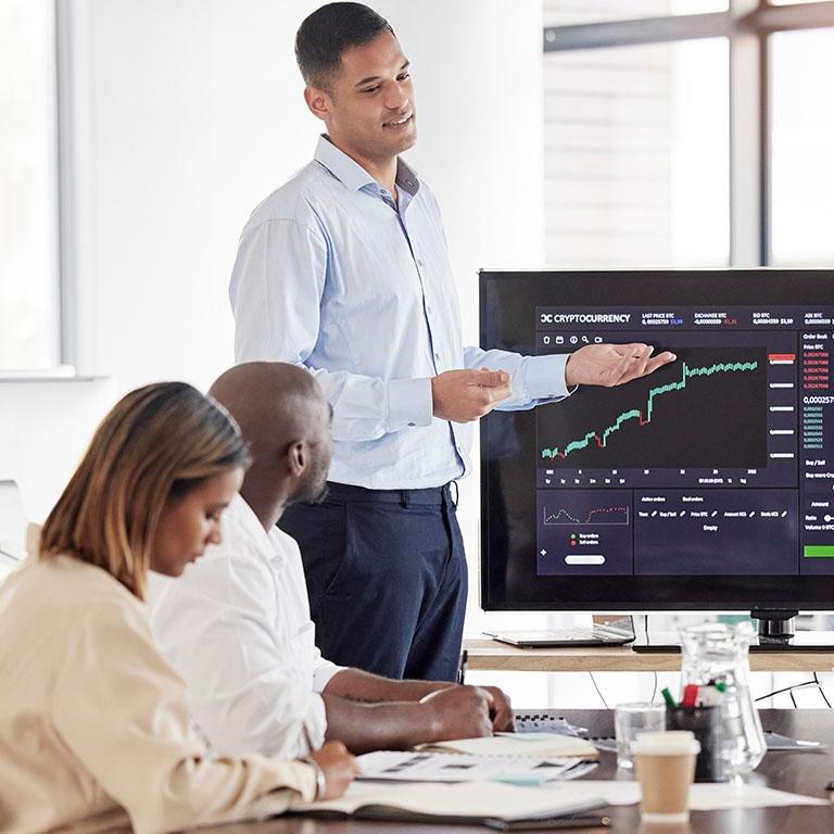 man presenting with a monitor screen with data